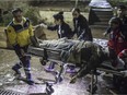 Paramedics carry a wounded person from the rubble of a mosque in Kilis, Turkey, near the border with Syria, Wednesday, Jan. 24, 2018. A Turkish official says two rockets fired from inside Syria hit the mosque during evening prayers and a house wounding at least 13 people. It was the latest in a series of rocket attacks against the Turkish border since Ankara launched a military offensive into Afrin to clear it of Syrian Kurdish militiamen whom it considers to be linked with Turkey's own Kurdish insurgents.