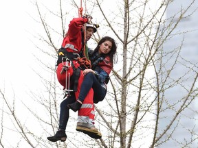 A woman is rescued from a downtown Toronto crane early Wednesday, April 26, 2017. THE CANADIAN PRESS/Frank Gunn