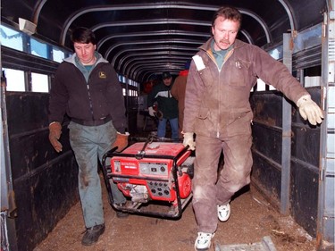 Ottawa 1998 Ice Storm - Doug Stevens, left, of Richmond helps unload some generators with Paul Robinson from Chatham at the Green Sales and Service depot in Richmond, On.   Dairy farmers are in desperate need of generators in order to milk the cows, power is out due to the worst ice storm in Canadian history.