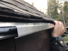 The Canadian made Edge-Cutter system uses an aluminum extrusion to deliver heat to melt rooftop ice along the eaves. Here the system is being installed in an existing roof.