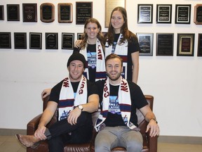 Jordan Wright, front left, with Will Roantree, and Sarah Reich,left rear, and Natalie Tershakowec model their DIFD scarves in advance of the U of O Law Classic game Feb. 3. Photo by Wayne Scanlan