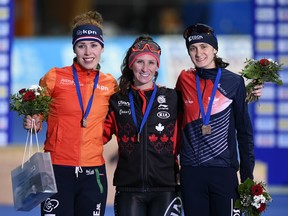 Winner Ivanie Blondin of Canada, center, celebrates on the podium besides second placed Antoinette de Jong of the Netherlands, left, and third placed Martina Sablikova of the Czech Republic, right, after the women's 3,000 meters distance at the Speed Skating World Cup in Erfurt, central Germany, Sunday, Jan. 21, 2018.