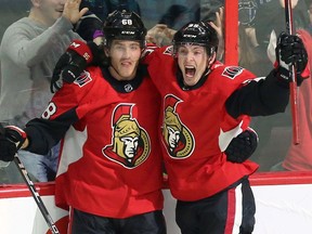 Senators centre Matt Duchene, right, rejoices with Mike Hoffman after scoring early in overtime to complete the team's rally for a 6-5 win over the Sharks at Canadian Tire Centre on Friday night.