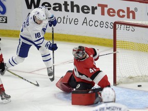 Maple Leafs centre Mitchell Marner (16) slips the puck past Senators' netminder Craig Anderson for the tying goal in the third period of Saturday's game at Canadian Tire Centre.