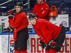 Canada's Boris Katchouk, right, and Dillon Dube look on during practice in Buffalo on Monday.