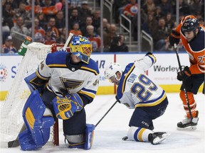 St. Louis defenceman Vince Dunn (29) stops a shot by Edmonton's Connor McDavid from entering the net during a game on Dec. 21.