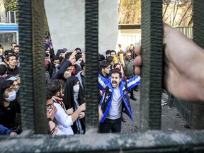 In this Saturday, Dec. 30, 2017 file photo, taken by an individual not employed by the Associated Press and obtained by the AP outside Iran, university students attend an anti-government protest inside Tehran University, in Tehran, Iran.