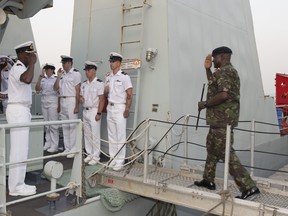 Lieutenant-Commander Paul Smith, Commanding Officer of HMCS Summerside greets Lieutenant General John Edson Milton, Chief of Defence Staff (Sierra Leone) as he comes aboard in Freetown, Sierra Leone during Obangame Express on March 19, 2017. Photo: MCpl Pat Blanchard, Canadian Forces Combat Camera.