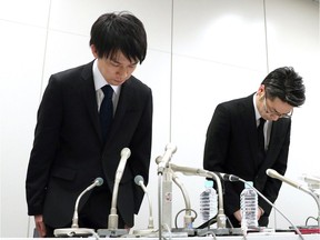 Coincheck President Koichiro Wada, left, bows in apology at the beginning of a news conference in Tokyo on Friday.  Takuya Inaba/Kyodo News via AP