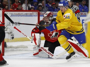 Sweden forward Lias Andersson (24) skates past Canada goalie Carter Hart (31) during the first period in the gold medal game of the world junior hockey championships, Friday, Jan. 5, 2018, in Buffalo, N.Y.