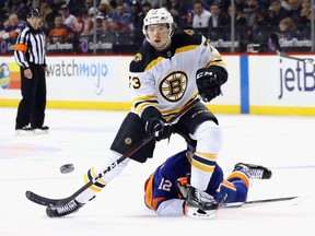 Charlie McAvoy of the Boston Bruins shoots the puck in against the New York Islanders during the third period at the Barclays Center on Jan. 18, 2018
