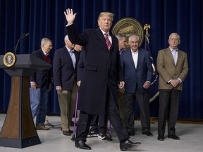 President Donald Trump, accompanied by Republican congressmen and members of his cabinet, departs after speaking at a news conference following a Congressional Republican Leadership Retreat at Camp David, Md., Saturday, Jan. 6, 2018.