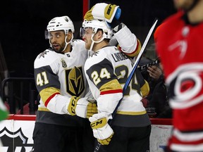 Golden Knights' Pierre-Edouard Bellemare (41) celebrates his goal against the Carolina Hurricanes with teammate Oscar Lindberg (24) during the first period of an NHL hockey game, Sunday, Jan. 21, 2018, in Raleigh, N.C.