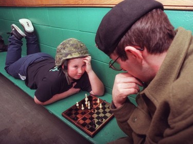 Ottawa 1998 Ice Storm - Nick Scott (11 years of at the time) plays chess with Trooper Greg Nowak from Toronto's Queens York Rangers at the Highlands Community Center in Lanark.