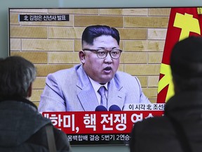 South Koreans watch a TV news program showing North Korean leader Kim Jong Un's New Year's address, at the Seoul Railway Station in South Korea, Monday, Jan. 1, 2018.