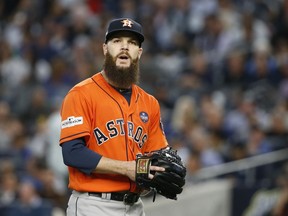 FILE - In this Oct. 18, 2017, file photo, Houston Astros starting pitcher Dallas Keuchel walks back to the dugout after the third inning of Game 5 of the baseball team's American League Championship Series against the New York Yankees in New York. Keuchel agreed to a $13.2 million, one-year contract after helping lead Houston to its first World Series title. Pitchers Lance McCullers Jr. and Brad Peacock and catcher Evan Gattis also reached one-year deals Friday, Jan. 12, when players and teams were set to swap proposed salaries in arbitration.