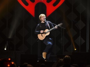 FILE - In this Dec. 8, 2017, file photo, singer-songwriter Ed Sheeran performs at Z100's iHeartRadio Jingle Ball at Madison Square Garden, in New York. Sheeran's album "Divide" was the most popular album of 2017, helping the music industry enjoy a growth spurt during the year, according to Nielsen Music.