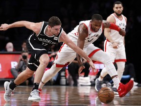 Brooklyn Nets' Joe Harris (12) battles for the ball with Toronto Raptors' CJ Miles (0) during the first half of an NBA basketball game Monday, Jan. 8, 2018, in New York.