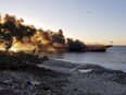 In this photo provided by Pasco County flames engulf a boat Sunday, Jan. 14, 2018, in the Tampa Bay area. The boat ferrying patrons to a casino ship off the Florida Gulf Coast caught fire near shore Sunday afternoon, and dozens of passengers and crew safely made it to land, authorities said.