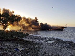 In this photo provided by Pasco County flames engulf a boat Sunday, Jan. 14, 2018, in the Tampa Bay area. The boat ferrying patrons to a casino ship off the Florida Gulf Coast caught fire near shore Sunday afternoon, and dozens of passengers and crew safely made it to land, authorities said.