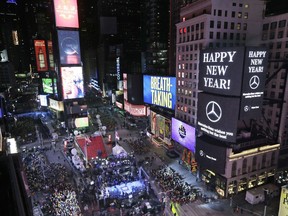 Revelers wait for midnight during New Year's celebrations in Times Square as seen from the Marriott Marquis in New York, Sunday, Dec. 31, 2017.