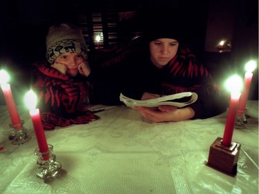 Ottawa 1998 Ice Storm - Allison Eagon, then 13, does her homework by candlelight in her family's Glebe Ave. home as sister Charlotte, 7, looks on Jan. 6, 1998.