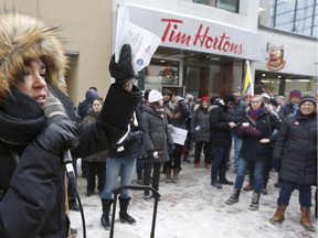 Union workers and supporters gathered to demonstrate in front of Tim Hortons on Sparks Street in Ottawa on Wednesday Jan 10, 2018. Karen Cocq, an organizer with Fight for $15 and Fairness, speaks at the rally. Tony Caldwell