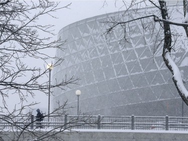 A man walks in the snow past the Ottawa Congress Centre in Ottawa Monday Jan 8, 2018.
