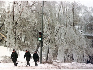 Twenty years ago, nearly five million Canadians in southeastern Quebec, eastern Ontario and parts of the Maritimes were battered by three successive waves of freezing rain between Jan. 5 and 10. Members of the Canadian Armed Forces walk to their headquarters in Westmount on Friday, January 9, 1998. The military are to assist at shelters. This is the fifth day of freezing rain in Montreal.