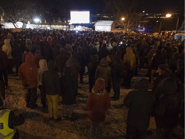 People are gathered at a vigil to commemorate the one-year anniversary of the Quebec City mosque shooting, in Quebec City, Monday, Jan. 29, 2018.