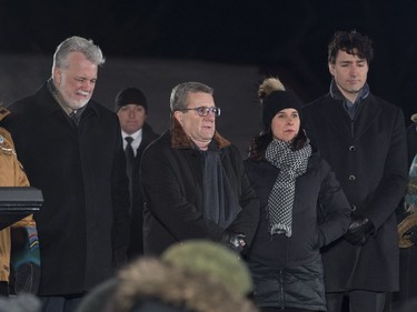 Quebec Premier Philippe Couillard, from the left, Quebec City mayor Regis Labeaume, Montreal mayor Valerie Plante and Prime Minister Justin Trudeau stand during a ceremony at a vigil to commemorate the one-year anniversary of the Quebec City mosque shooting, in Quebec City, Monday, Jan. 29, 2018.