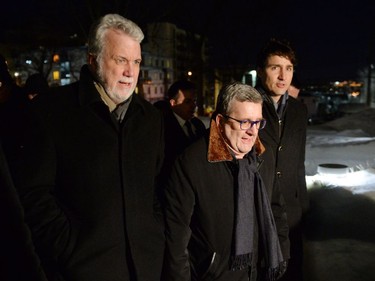 Quebec Premier Philippe Couillard, left to right, Quebec City Mayor Regis Labeaume and Prime Minister Justin Trudeau attend a vigil to commemorate the one-year anniversary of the Quebec City mosque shooting, in Quebec City, Monday, Jan. 29, 2018.