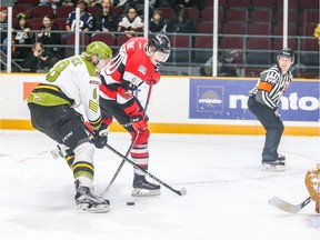 67's forward Oliver True attempts to release a shot while being checked by Riley Bruce (8) of the Battalion during the first period. Valerie Wutti/Blitzen Photography/OSEG