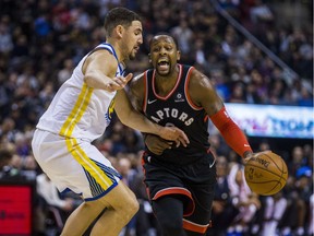 The Raptors' C.J. Miles tries to dribble past Warriors guard Klay Thompson during the first half of play at Air Canada Centre on Saturday night.