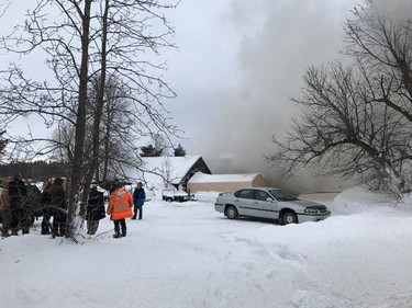 Stagecoach Rd - firefighters now in defensive attack. 3 cars were removed from area to limit damage. Garage involved in fire with 2 storey home. Family & friends remain on scene.