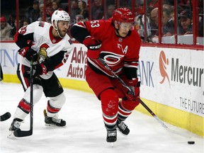 Carolina Hurricanes' Jeff Skinner (53) works the puck agains Ottawa Senators' Fredrik Claesson (33) during the second period of an NHL hockey game, Tuesday, Jan. 30, 2018, in Raleigh, N.C.