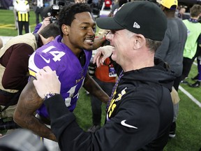 Minnesota Vikings wide receiver Stefon Diggs (14) celebrates with offensive coordinator Pat Shurmur in Minneapolis, Sunday, Jan. 14, 2018. (AP Photo/Charlie Neibergall)