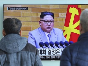 People watch a TV screen showing North Korean leader Kim Jong-un's New Year's speech, at Seoul Railway Station in Seoul, South Korea, Wednesday, Jan. 3.