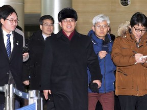 Yun Yong Bok, center, deputy director of the North Korean Ministry of Physical Culture and Sports, arrives at the Customs Immigration and Quarantine office in Paju, South Korea, to return home Saturday, Jan. 27, 2018. North Korean officials on Saturday wrapped up a three-day visit to South Korea where they examined Olympic stadiums, hotels and concert halls that will potentially be used by North Korean athletes and other delegates headed to next month's Pyeongchang Winter Games.