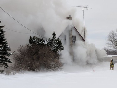 Firefighter on scene of smoky blaze in farmhouse on 3220 Stagecoach Rd., Tuesday, Jan. 9.