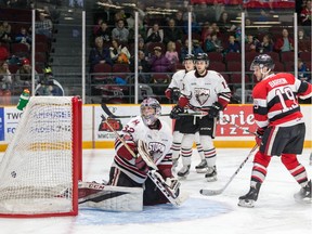 Travis Barron of the Ottawa 67's watches the puck sail past Storm goalie Anthony Popovich.