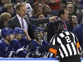 Tampa Bay Lightning coach Jon Cooper argues with official Mike Hasenfratz (2) during a home game against the Minnesota Wild on Dec. 23.