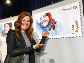 Olympic Speed Skater and Cyclist, Clara Hughes checks out her stamp as Canada Post unveiled five stamps to honour six barrier breaking role models at Canada's Sports Hall of Fame in Calgary, Alta., on Wednesday, January 24, 2018.