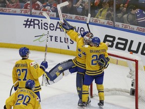 Sweden celebrates a 4-2 victory over the United States following the third period of a semifinal in the IIHF world junior hockey championships, Thursday, Jan. 4, 2018, in Buffalo, N.Y.