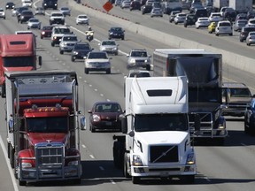 FILE - In this Aug. 24, 2016, file photo, truck and automobile traffic mix on Interstate 5, headed north through Fife, Wash., near the Port of Tacoma. President Donald Trump's plan to beef up the nation's infrastructure will contain a crater-sized hole when it's unveiled next month. The trust fund that pays for most federal highway and transit aid is forecast to go broke in about three years unless the government significantly scales back its transportation spending or comes up with more money.