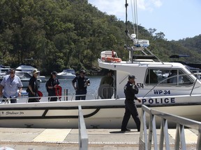 Police and and Australian Transport Safety Bureau investigators board a police boat to go the scene of a seaplane crash in the Hawkesbury River near Sydney, Monday, Jan. 1, 2018. Police divers recovered the bodies of all six victims a few hours after the crash on Sunday, New South Wales police said.