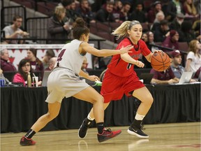 Ravens guard Alexandra Trivieri dribbles against  Gee-Gees Brooklynn McAlear-Fanus during the 12th annual Capital Hoops Classic women's game at Canadian Tire Centre. Jana Chytilova/Postmedia