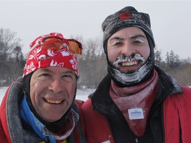 Estan Beedell, right, and his father Jeff Beedell take part in the Winterlude Triathlon on the Rideau Canal skateway in Ottawa on Saturday, February 3, 2018.