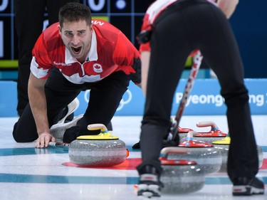 Canada's John Morris shouts instructions as Kaitlyn Lawes brushes the ice surface during the Pyeongchang 2018 Winter Olympic Games at the Gangneung Curling Centre in Gangneung on February 12, 2018.