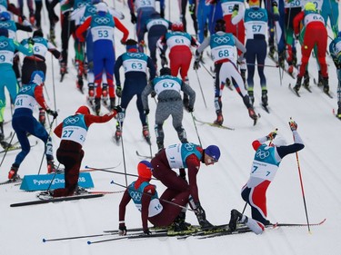 TOPSHOT - (From L) Russia's Denis Spitsov, Russia's Andrey Larkov and Norway's Simen Hegstad Krueger recover after colliding at the start of the men's 15km + 15km cross-country skiathlon at the Alpensia cross country ski centre during the Pyeongchang 2018 Winter Olympic Games on February 11, 2018 in Pyeongchang.
